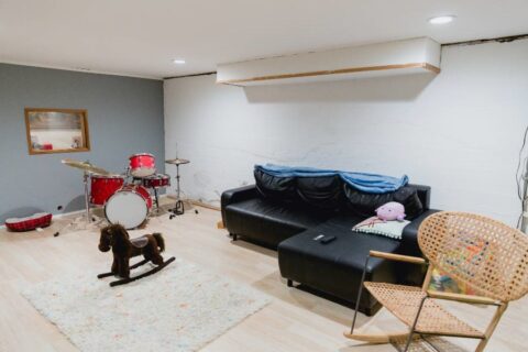  A living room scene with a rocking horse, drum kit, and a plush couch for relaxation.in Chicago, IL