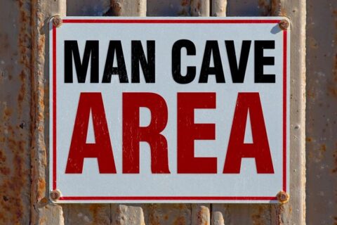 Sign for a man cave displayed on a weathered, rusty wall in Chicago, IL