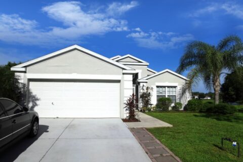White single-story home with attached garage under blue sky in Chicago, IL