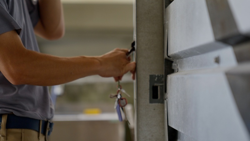 A man is trying to lock the garage door in Chicago, IL
