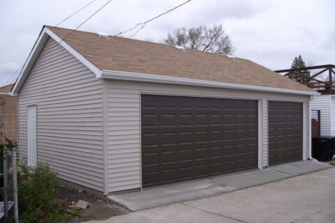 Residential garage building with two large garage doors